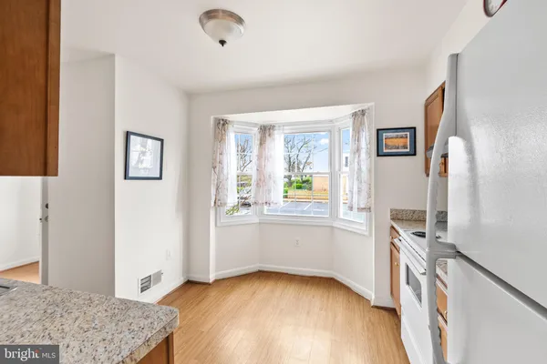 a view of kitchen with furniture and wooden floor
