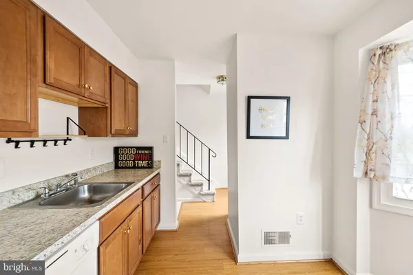 a kitchen with stainless steel appliances granite countertop a sink stove and cabinets