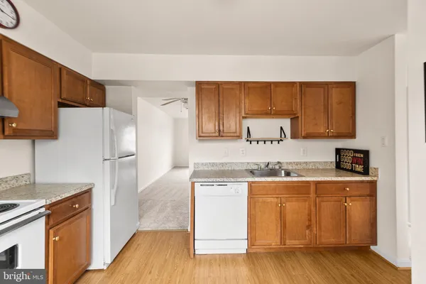 a kitchen with a sink a refrigerator and cabinets