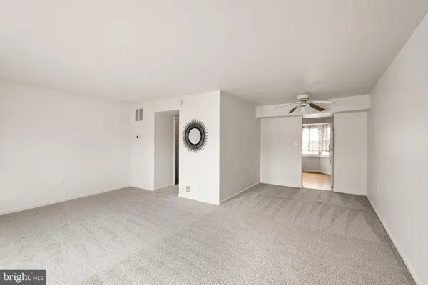 an empty room with windows and entrance
