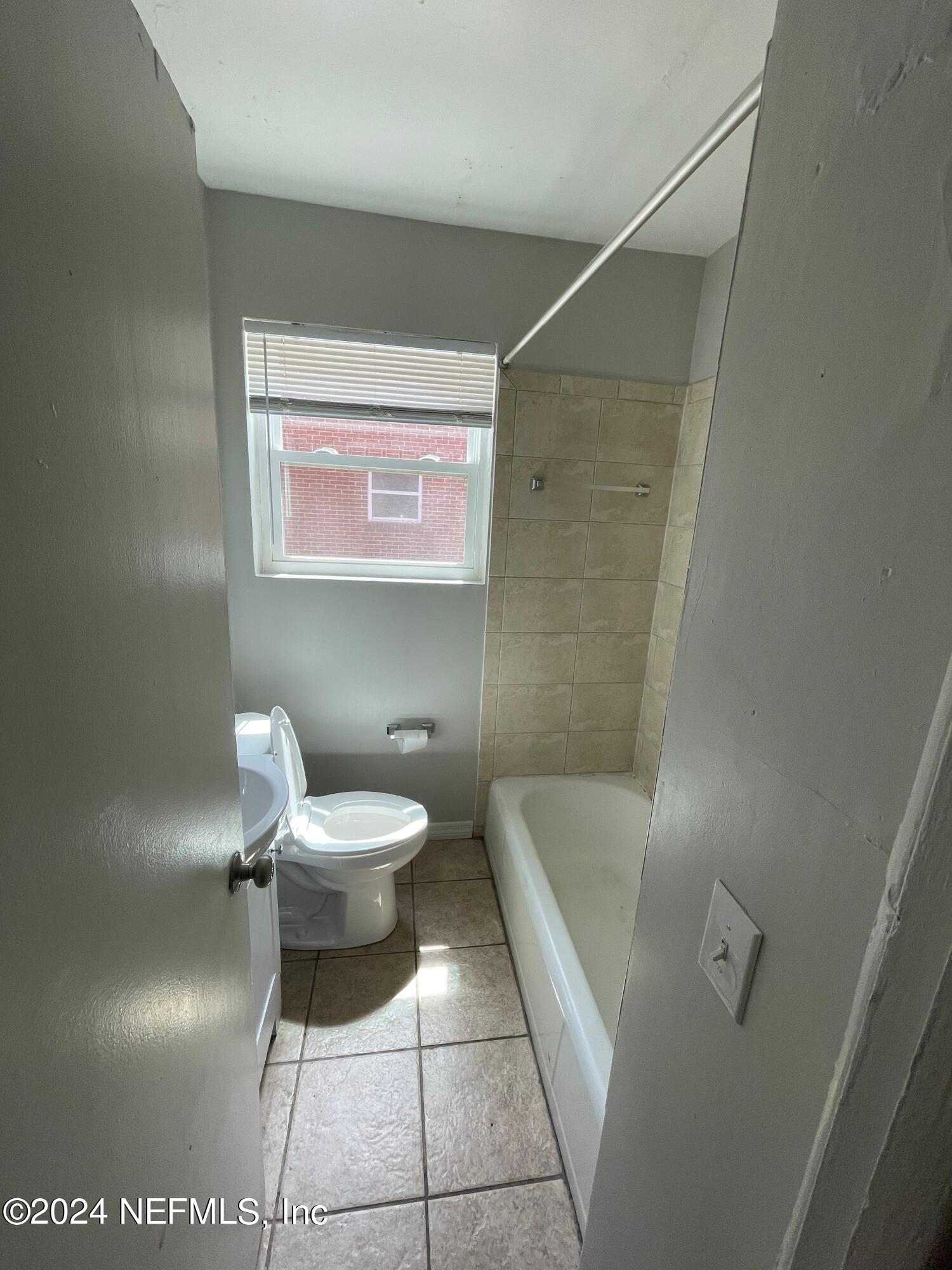 2117 Spring Park Road, Unit 2 Jacksonville, FL 32207 - Photo 2 of 9 a bathroom with a toilet and a shower