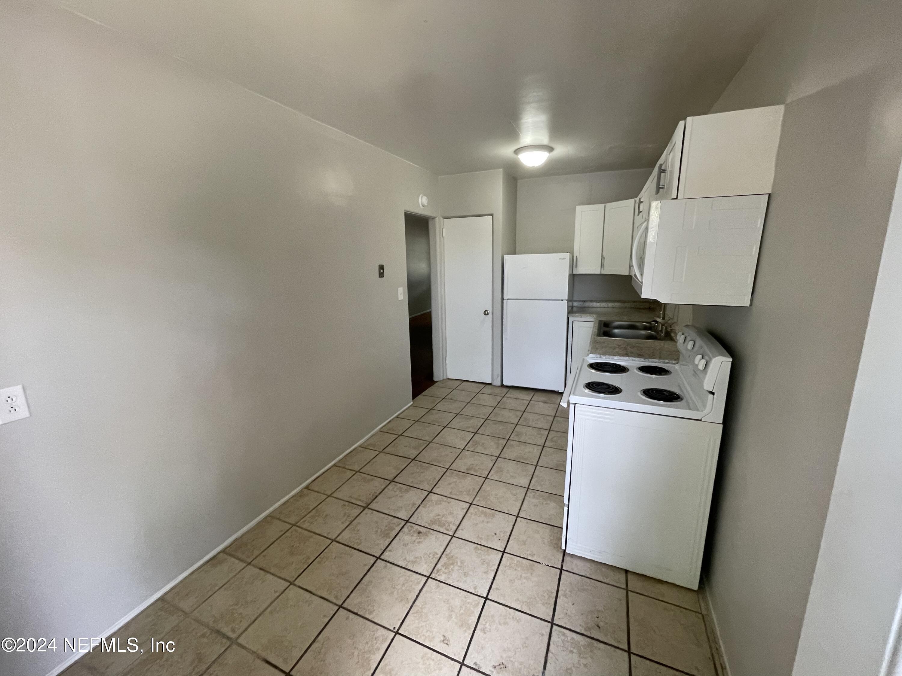 2117 Spring Park Road, Unit 2 Jacksonville, FL 32207 - Photo 5 of 9 a kitchen with stainless steel appliances a refrigerator sink and stove