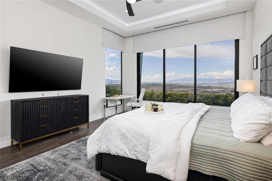 611 Cityview Ridge Drive Henderson, NV 89012 - Photo 48 of 66 Massive floor-to-ceiling windows frame elevated valley and mountain views from this modern bedroom.