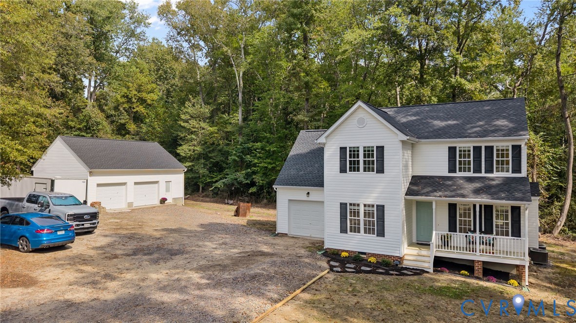 a front view of a house with a yard and trees