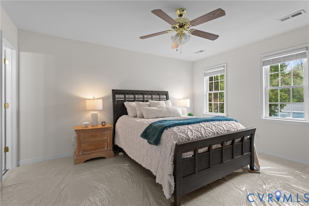 5211 Alberta Road Chesterfield, VA 23832 - Photo 26 of 43 a bed sitting in a bedroom next to a window