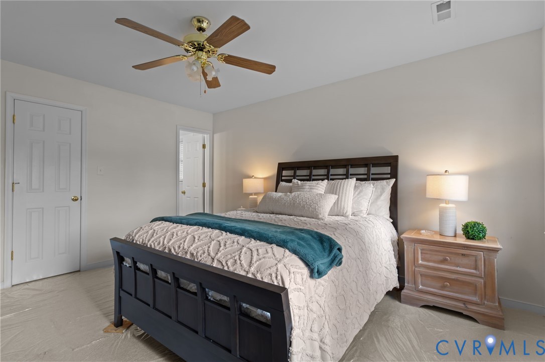 5211 Alberta Road Chesterfield, VA 23832 - Photo 27 of 43 a bedroom with a bed and a chandelier