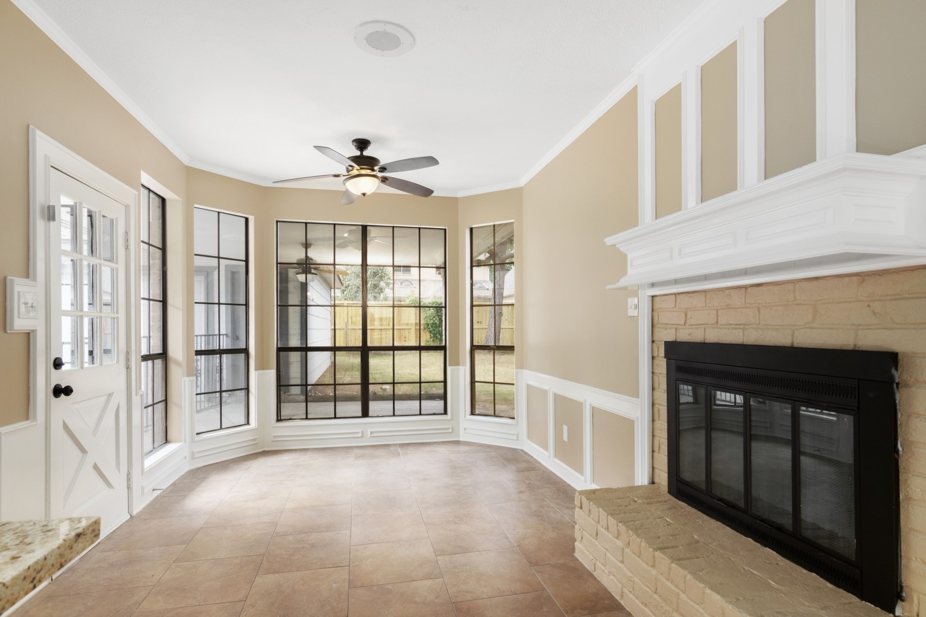 6039 Spring Creek Lane Spring, TX 77379 - Photo 11 of 48 a view of an empty room with chandelier fan and windows