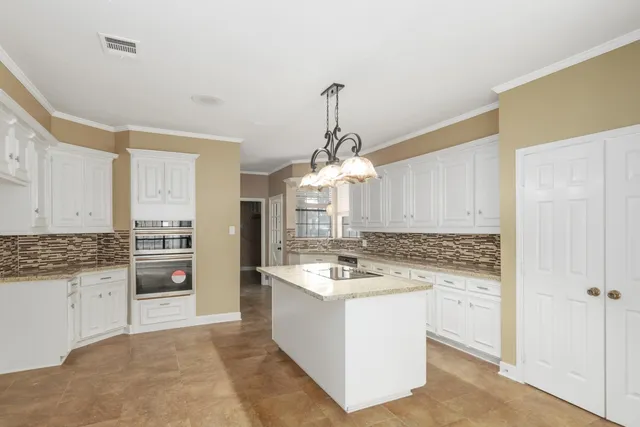 a kitchen with a sink stove and cabinets