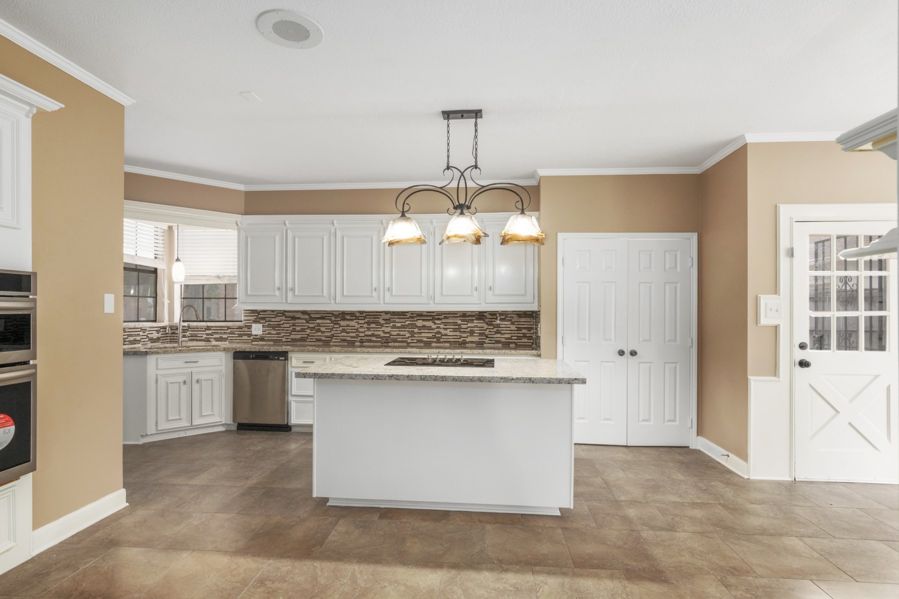 6039 Spring Creek Lane Spring, TX 77379 - Photo 18 of 48 a kitchen with kitchen island granite countertop a sink stove and refrigerator