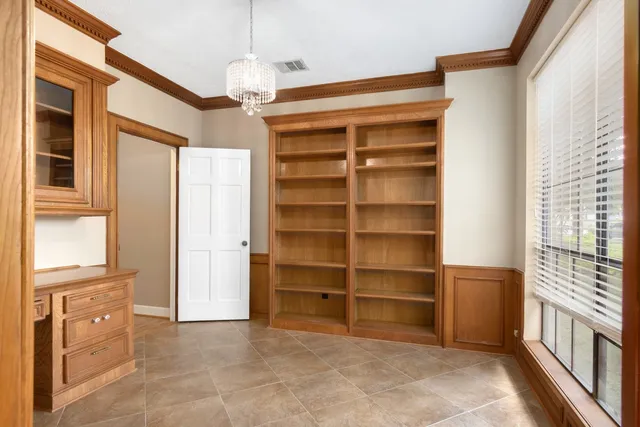 a view of a bedroom with a cabinet and a flat screen tv