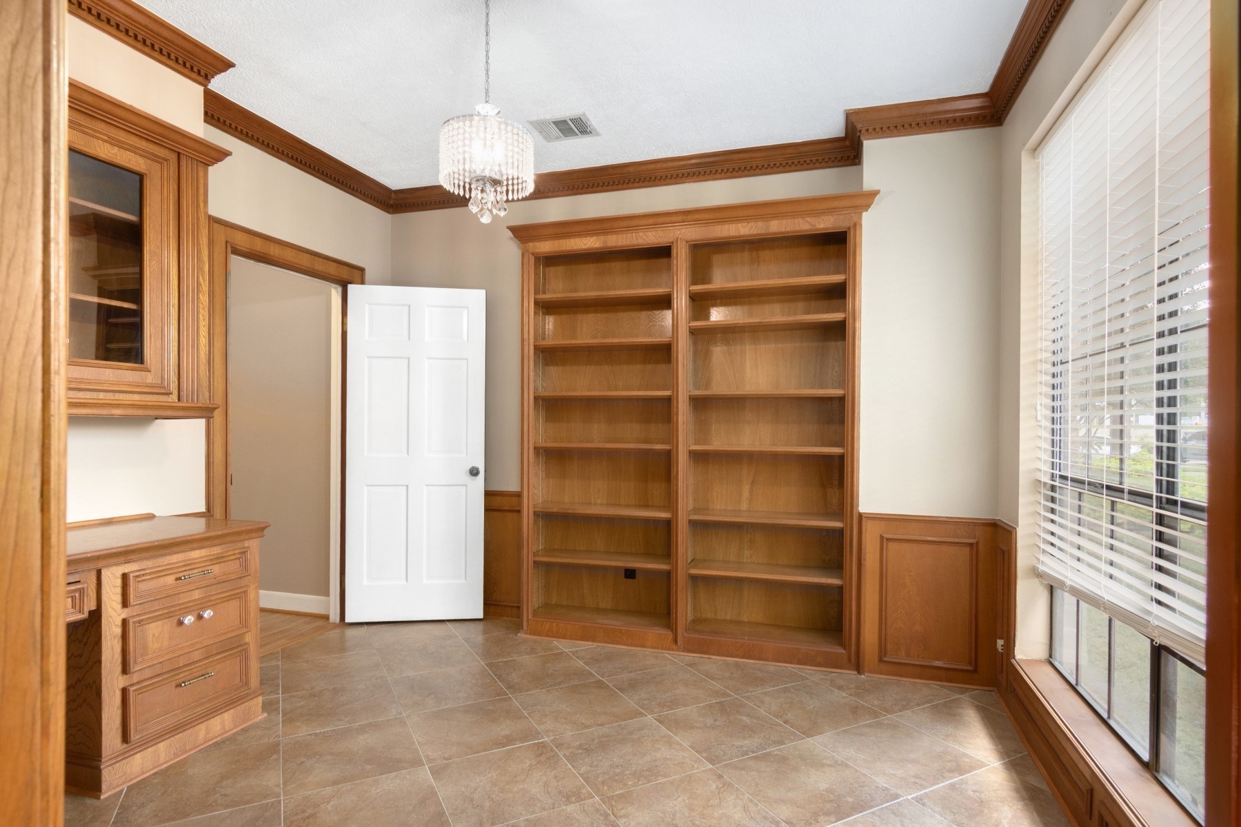 6039 Spring Creek Lane Spring, TX 77379 - Photo 21 of 48 a view of a bedroom with a cabinet and a flat screen tv