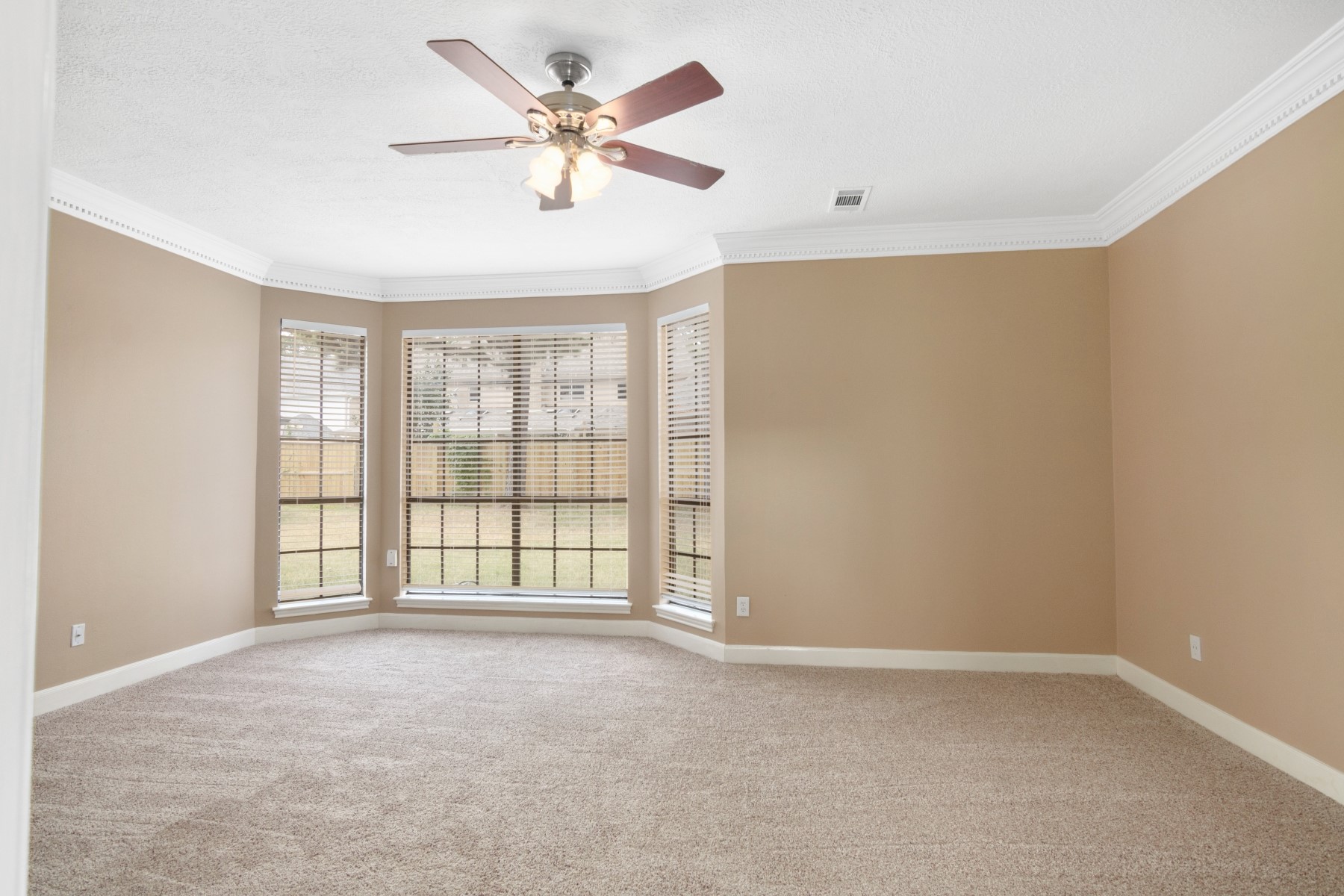 6039 Spring Creek Lane Spring, TX 77379 - Photo 30 of 48 an empty room with chandelier fan and windows