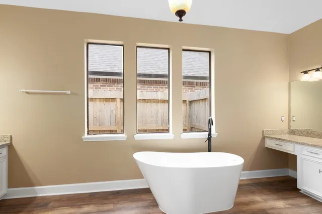 a white bath tub sitting next to a window