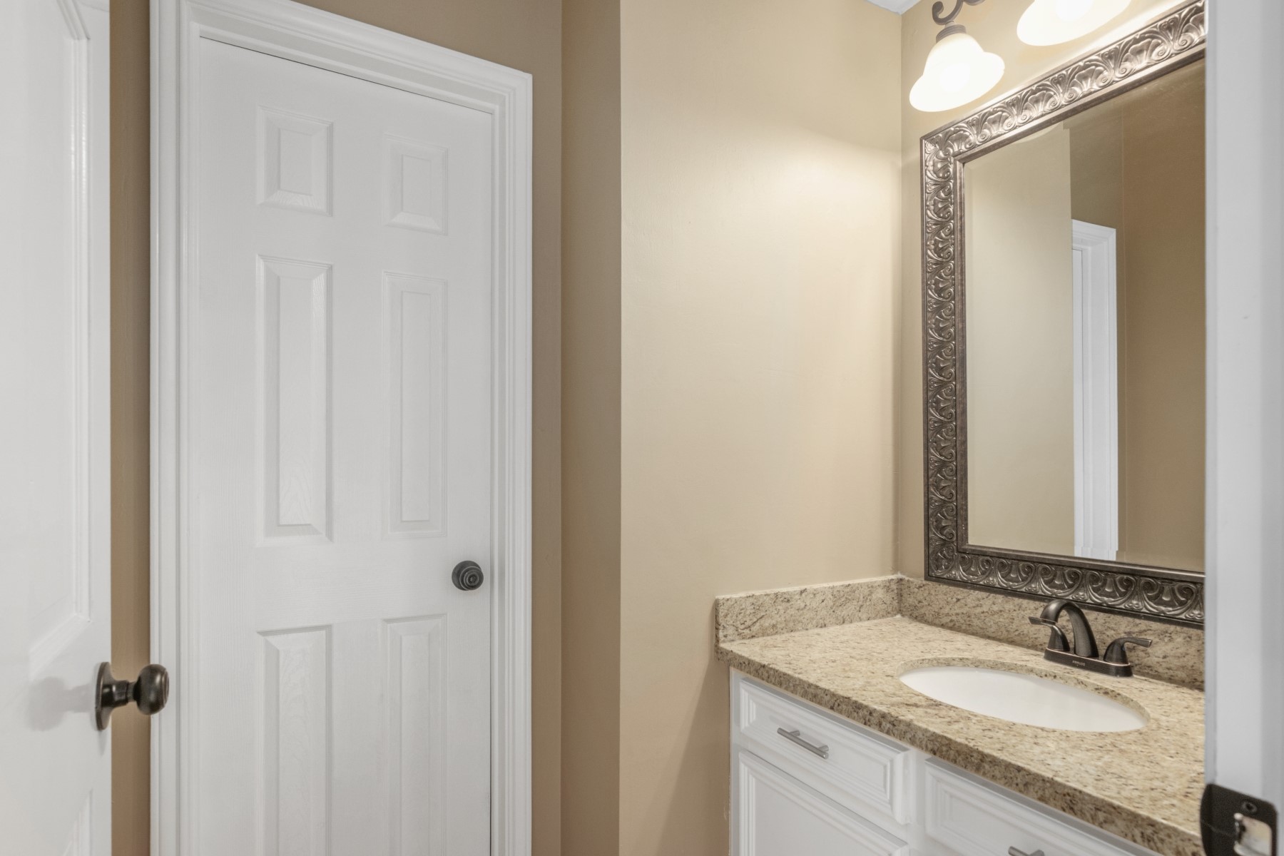 6039 Spring Creek Lane Spring, TX 77379 - Photo 43 of 48 a bathroom with a granite countertop sink and a mirror