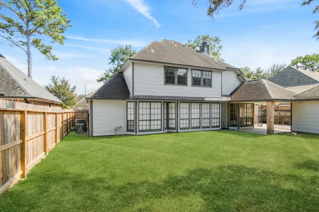 a view of a house with a yard and sitting area