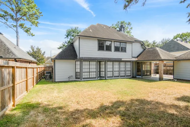 a view of a house with a yard and sitting area