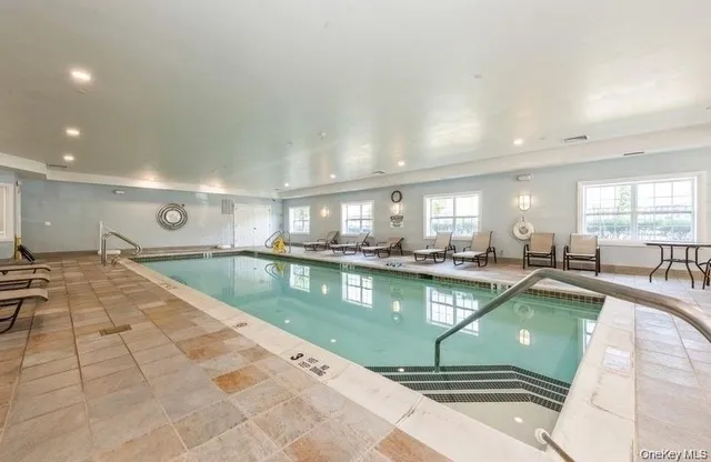 a kitchen with stainless steel appliances granite countertop a sink a counter top cabinets and living room view