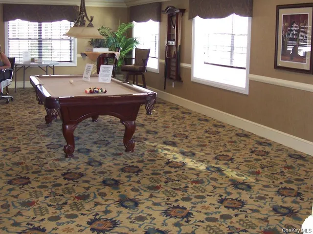 a view of a dining room with furniture and window