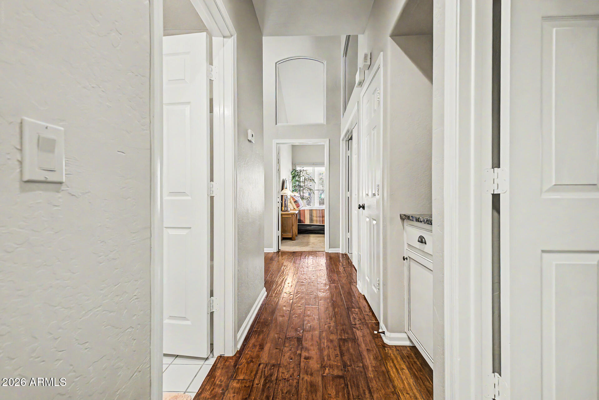 4309 East Rancho Caliente Drive Cave Creek, AZ 85331 - Photo 18 of 37 a view of a hallway with wooden floor and staircase