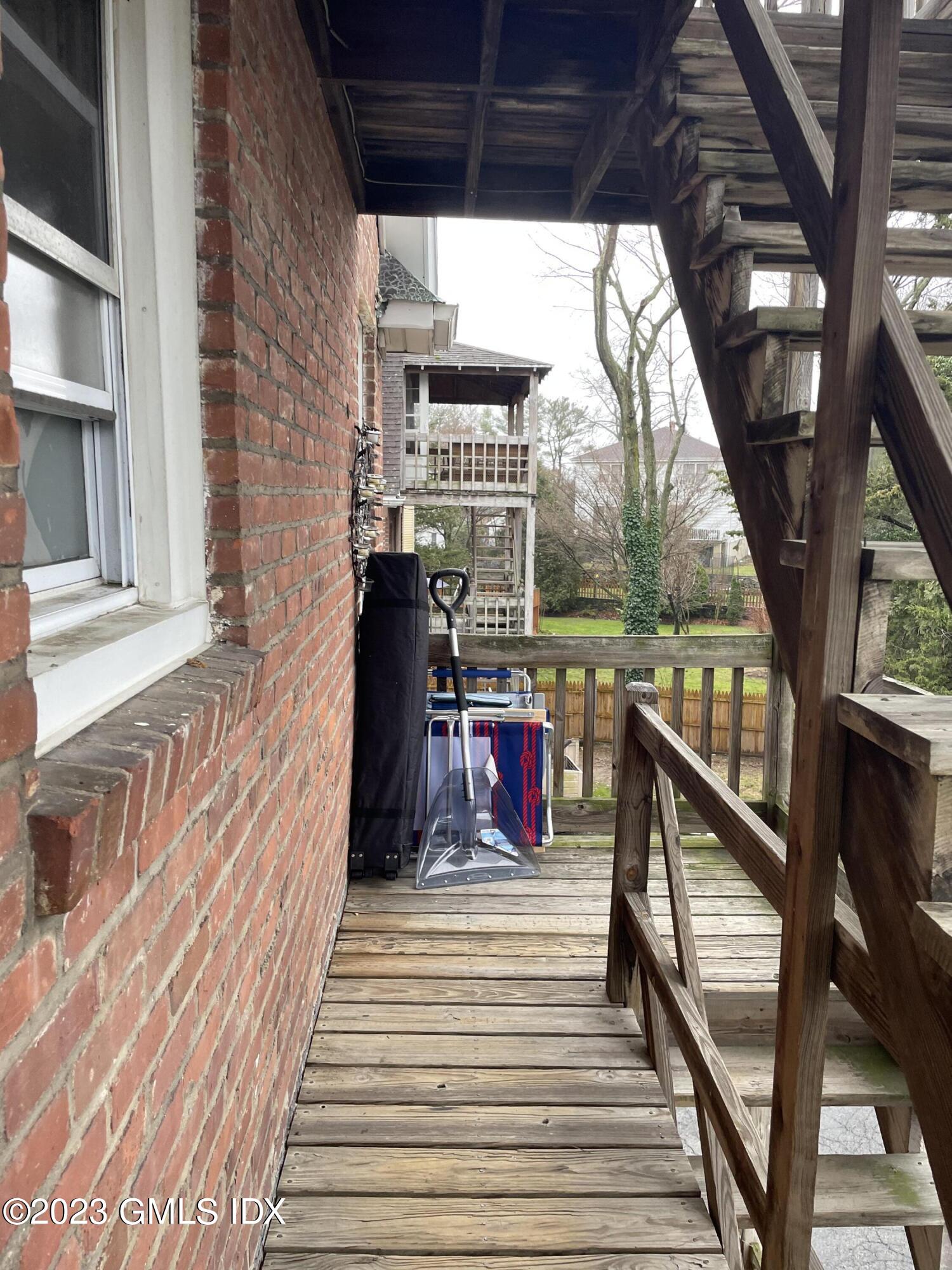 60 Weaver Street, Unit 2 Greenwich, CT 06831 - Photo 3 of 20 a view of a balcony with wooden floor and stairs