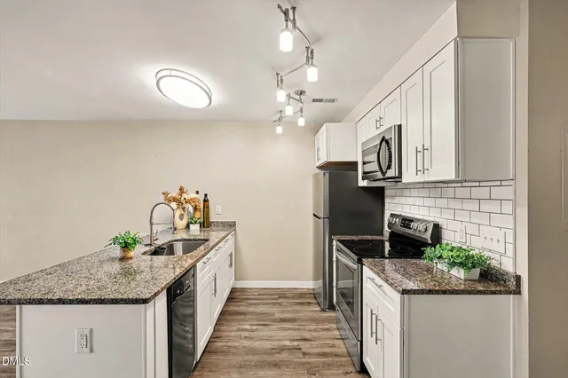 a kitchen that has a sink and a stove in it