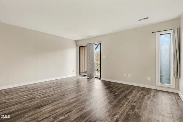 a kitchen with stainless steel appliances kitchen island granite countertop a refrigerator and microwave