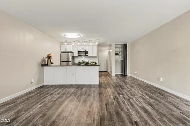 a view of a kitchen with a sink and a refrigerator
