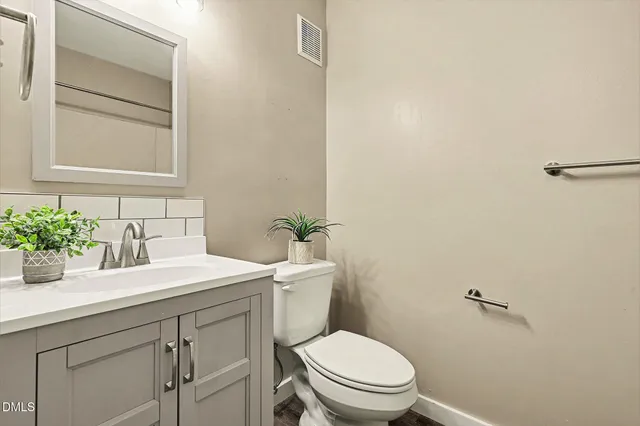 a spacious bathroom with a toilet and a shower