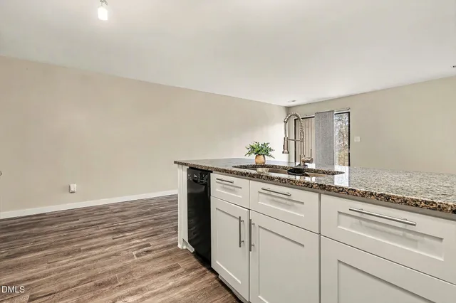 a kitchen with refrigerator a stove and cabinets