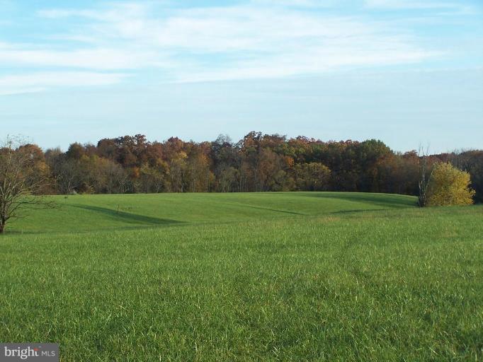 14413 Old Frederick Road Rocky Ridge, MD 21778 - Photo 1 of 26 a view of a field of grass and an ocean view