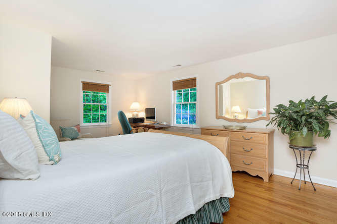 23 Stoney Ridge Lane Riverside, CT 06878 - Photo 18 of 21 a bedroom with a bed potted plant on dresser and a window