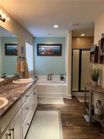 a spacious bathroom with a tub and a sink