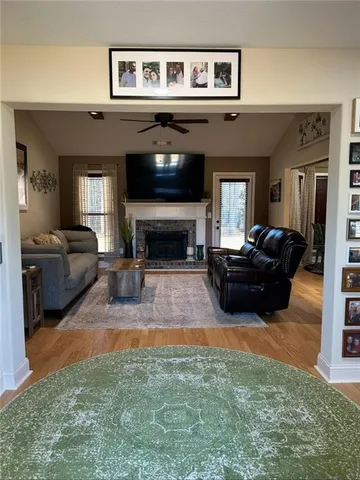 a living room with furniture a flat screen tv and a fireplace