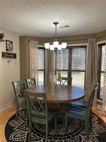 a view of a dining room with furniture and chandelier