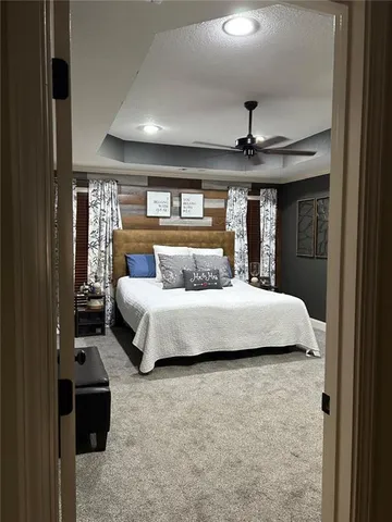 a bedroom with a large bed and a chandelier