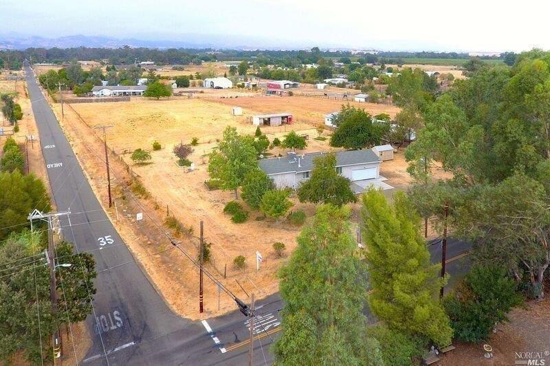 This 2.1 acre lot is located on a corner with Locke Rd as front entrance to the circular driveway to this home.  If you want to put a barn or large building on back part of lot you could make an entrance off Udell Rd. Wood stove can heat whole house. Ceiling fans in all rooms. Additional attic insulation.  Newer dual pane windows on south side of home. Newer front door.  Newer stucco on east and south side of home. 2 storage sheds installed in 2014.  Paid for solar panels installed in 2015. HVAC installed this June. Almost every month something to pick from one of the 15 fruit trees. Property is fenced. Older wood out building in back half of the lot.  Only 5 minutes from Hwy 505.