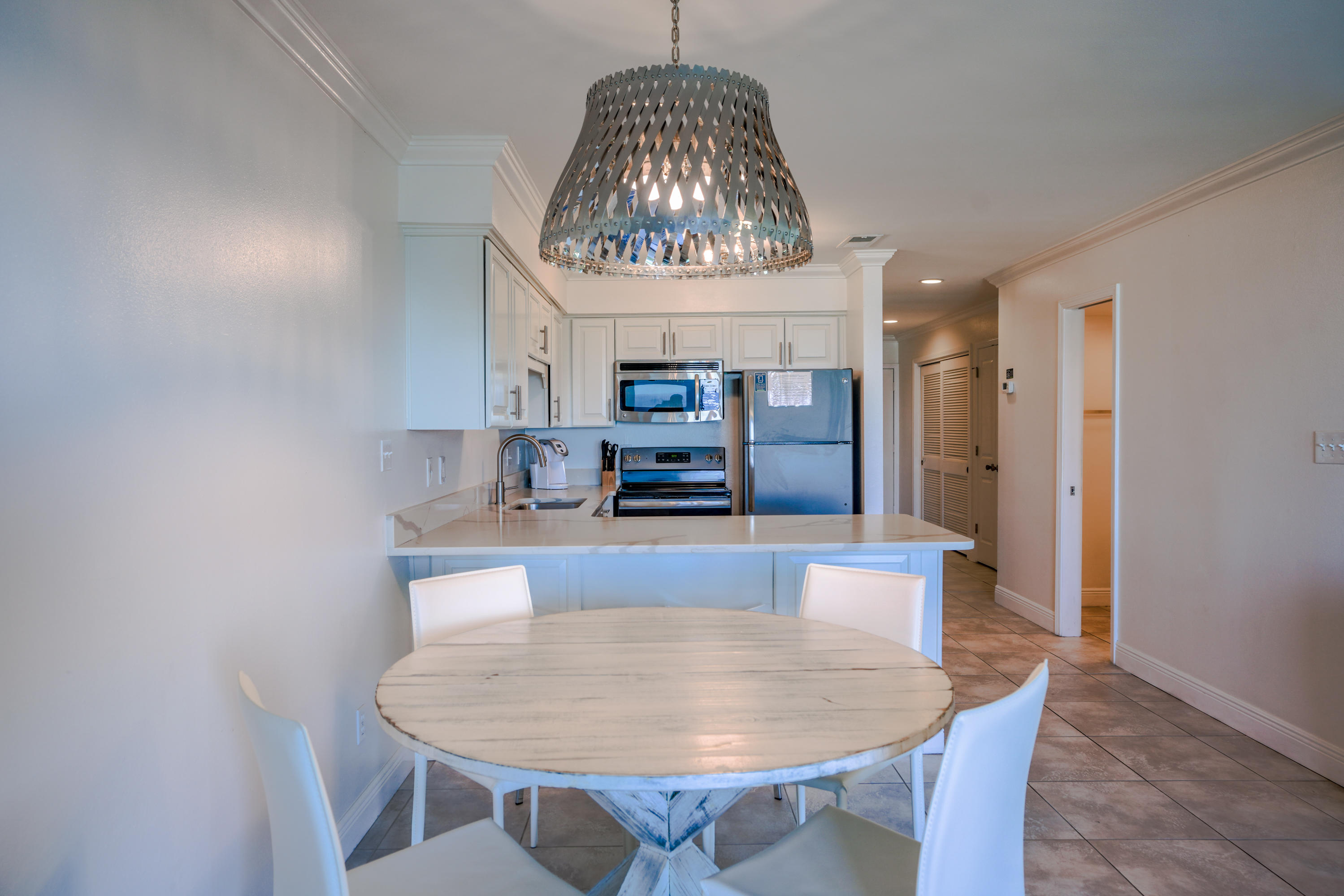 214 Blue Mountain Road, Unit 112 Santa Rosa Beach, FL 32459 - Photo 11 of 19 a living room with furniture and a chandelier