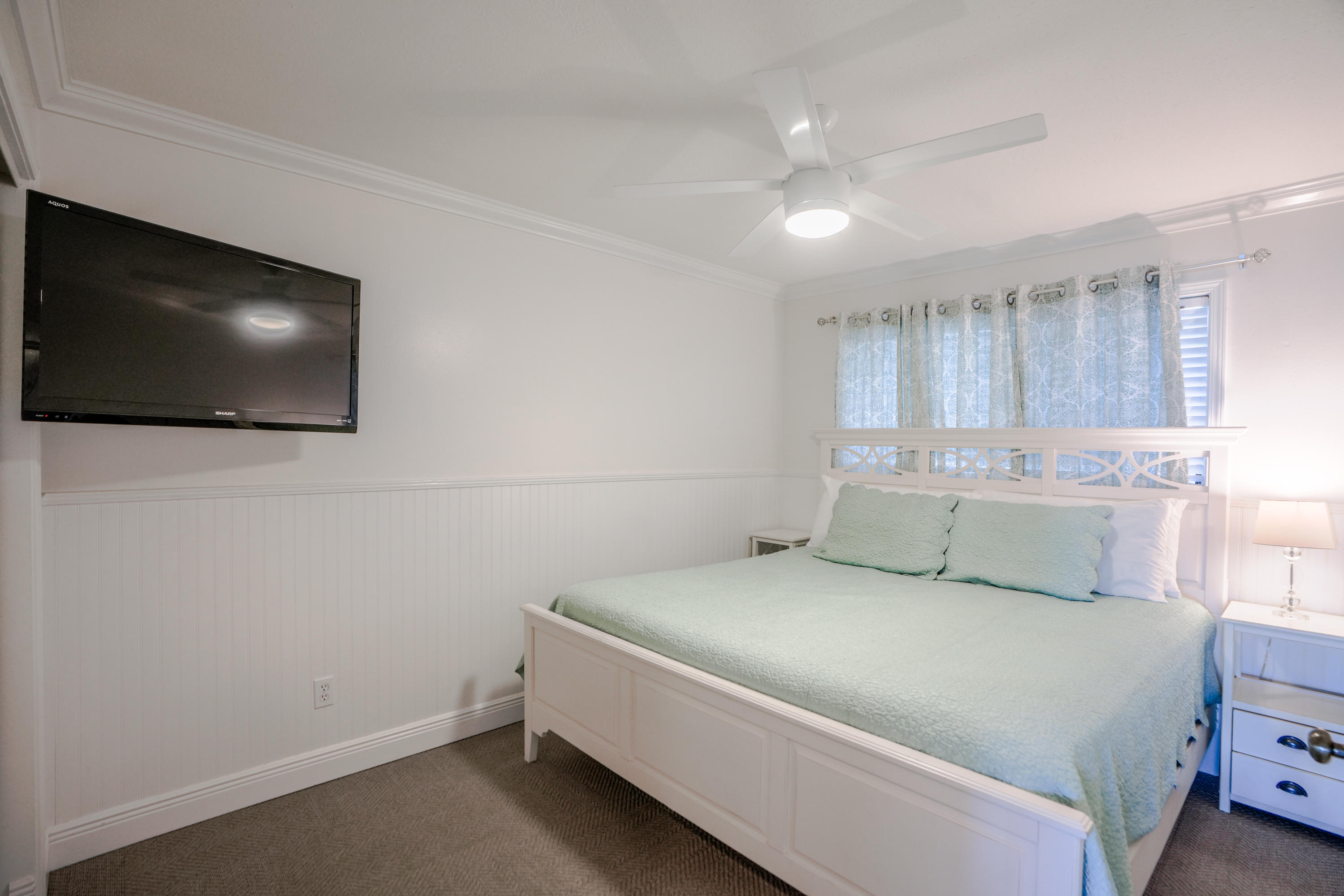 214 Blue Mountain Road, Unit 112 Santa Rosa Beach, FL 32459 - Photo 12 of 19 a bedroom with a bed and a flat screen tv
