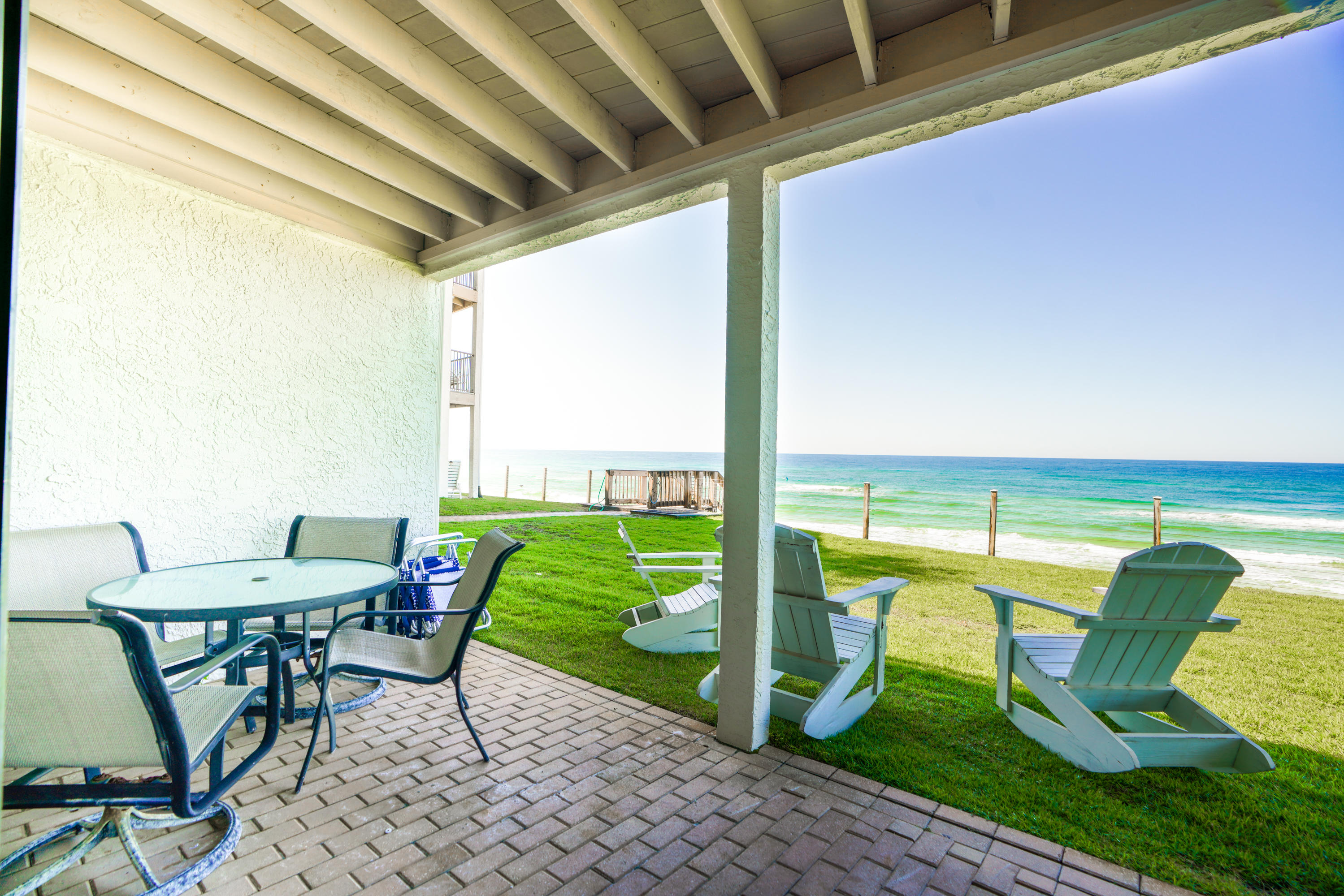 214 Blue Mountain Road, Unit 112 Santa Rosa Beach, FL 32459 - Photo 15 of 19 a view of a chairs and table in patio with a backyard