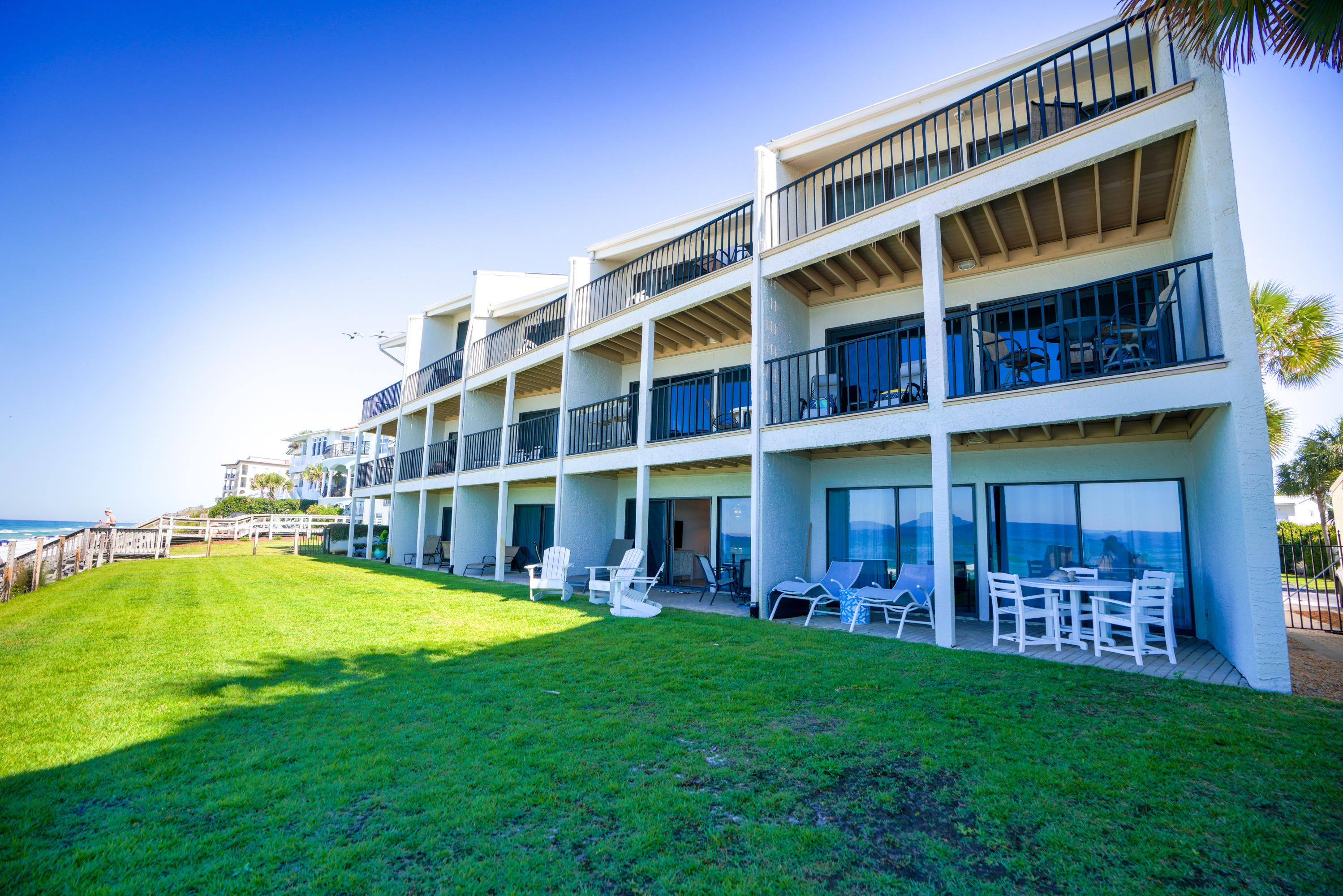 214 Blue Mountain Road, Unit 112 Santa Rosa Beach, FL 32459 - Photo 18 of 19 a view of building with yard in front of it