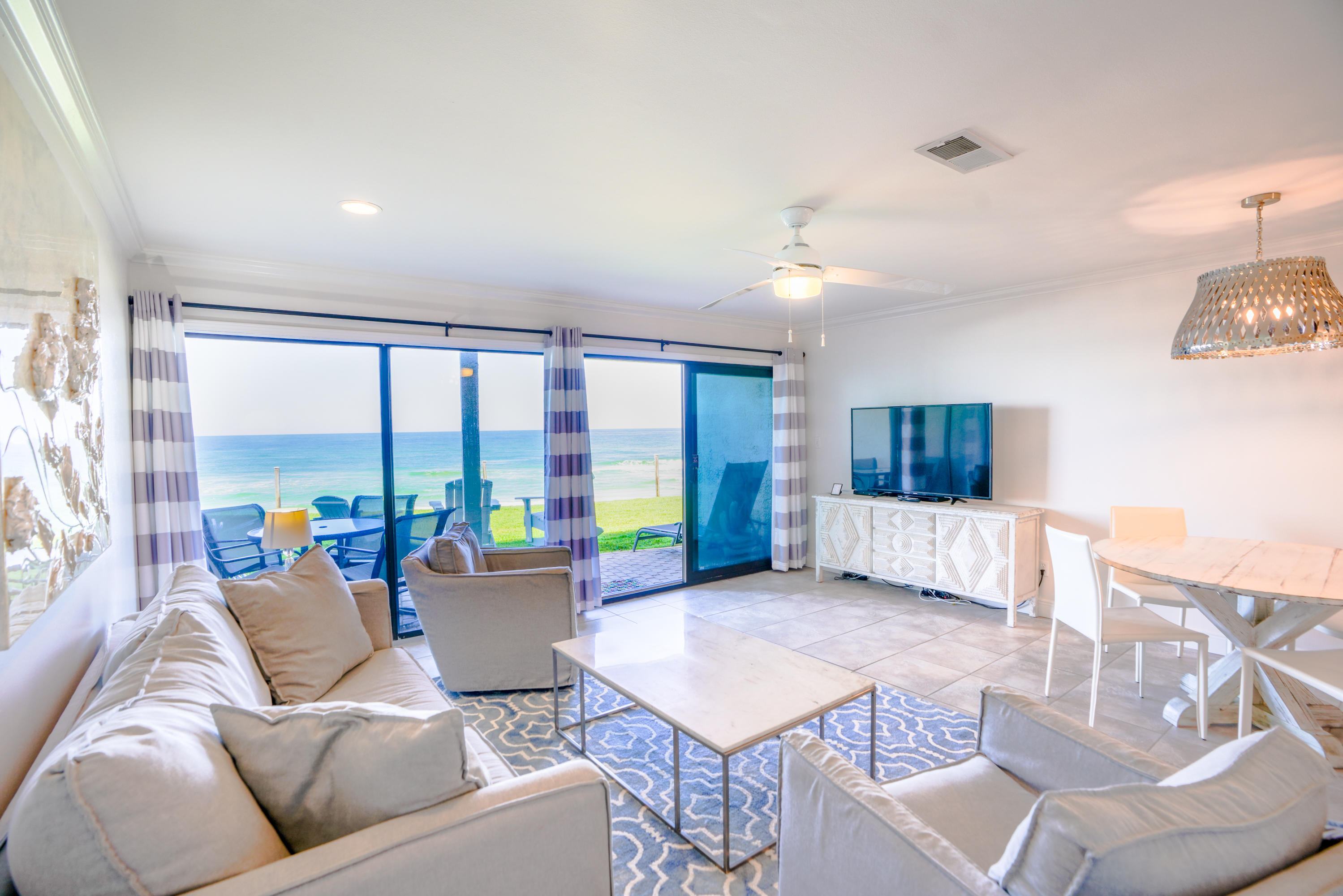 214 Blue Mountain Road, Unit 112 Santa Rosa Beach, FL 32459 - Photo 2 of 19 a living room with furniture and large windows