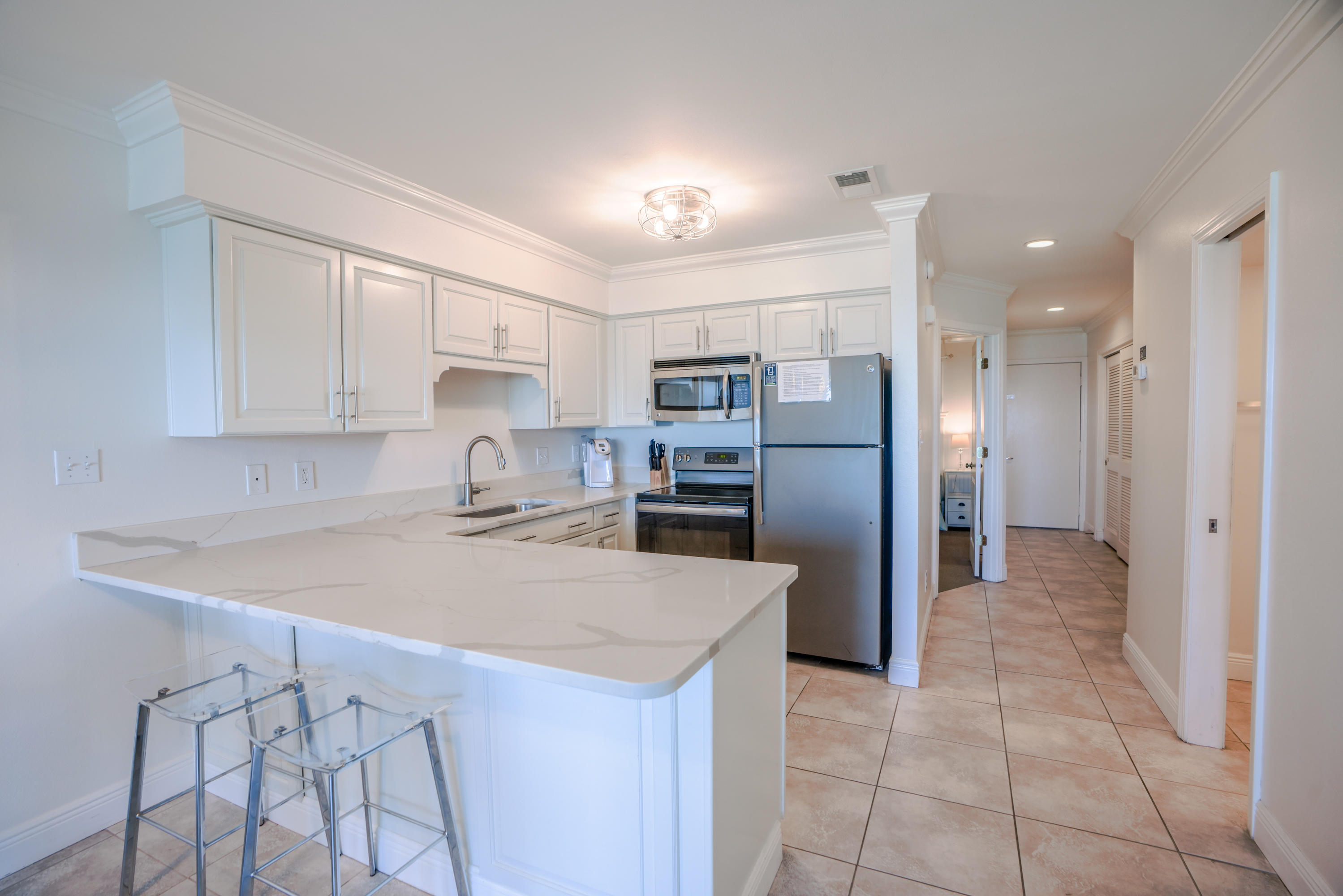 214 Blue Mountain Road, Unit 112 Santa Rosa Beach, FL 32459 - Photo 10 of 19 a kitchen with stainless steel appliances a refrigerator sink and cabinets