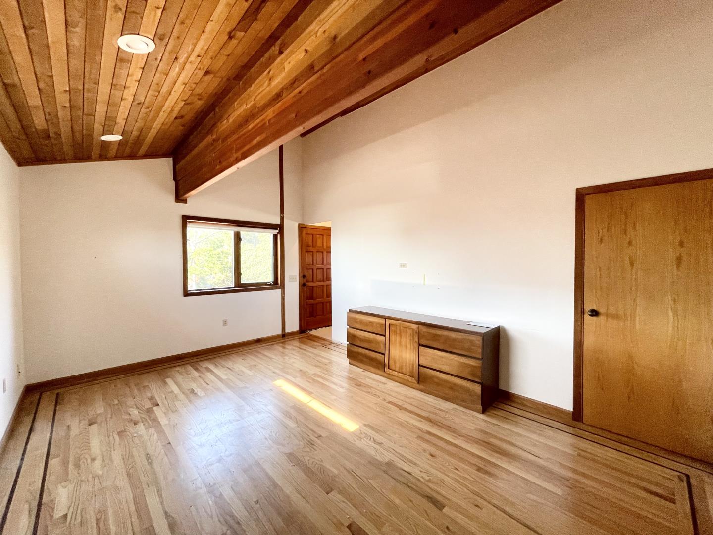 490 Talbot Avenue Pacifica, CA 94044 - Photo 13 of 33 a view of an empty room with wooden floor and a window