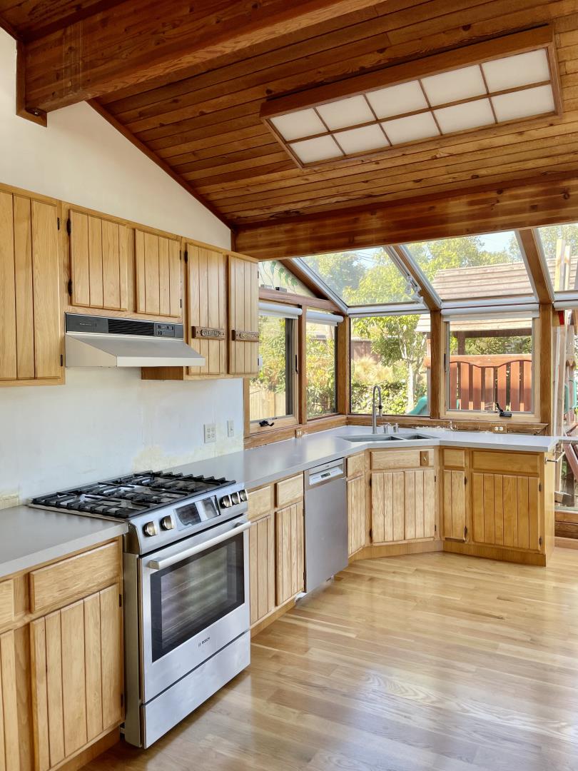 490 Talbot Avenue Pacifica, CA 94044 - Photo 4 of 33 a kitchen with stainless steel appliances granite countertop a stove and a sink