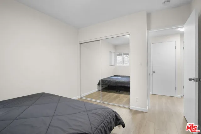 a bedroom with a bed and a chair