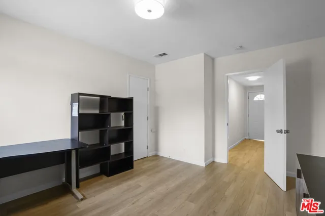 a view of bedroom with wooden floor
