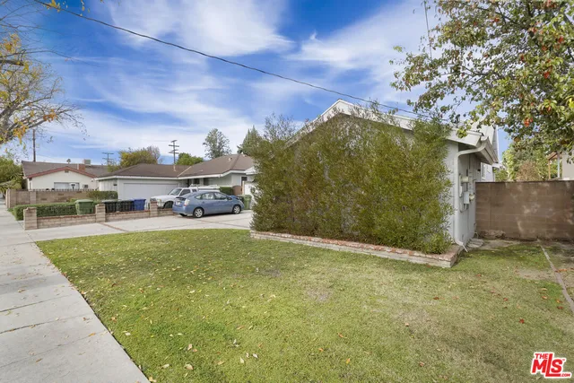 a view of a big yard with large trees