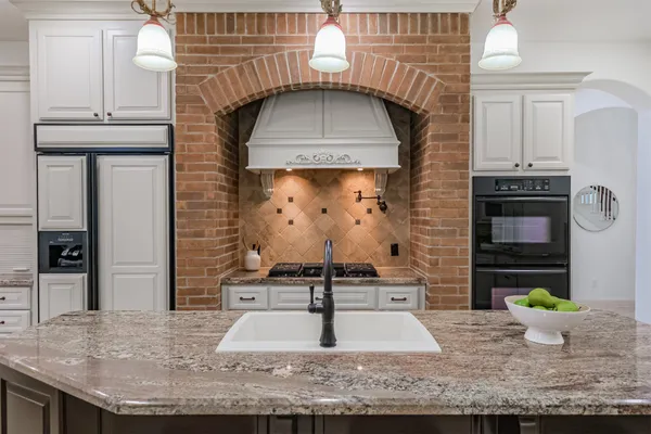a spacious bathroom with a granite countertop tub sink and mirror