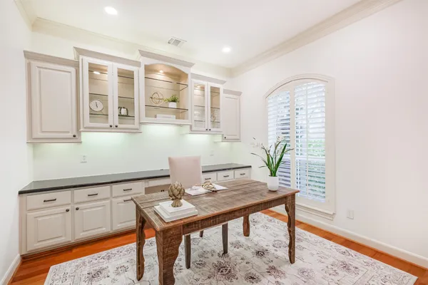 a bathroom with a granite countertop sink a toilet and mirror