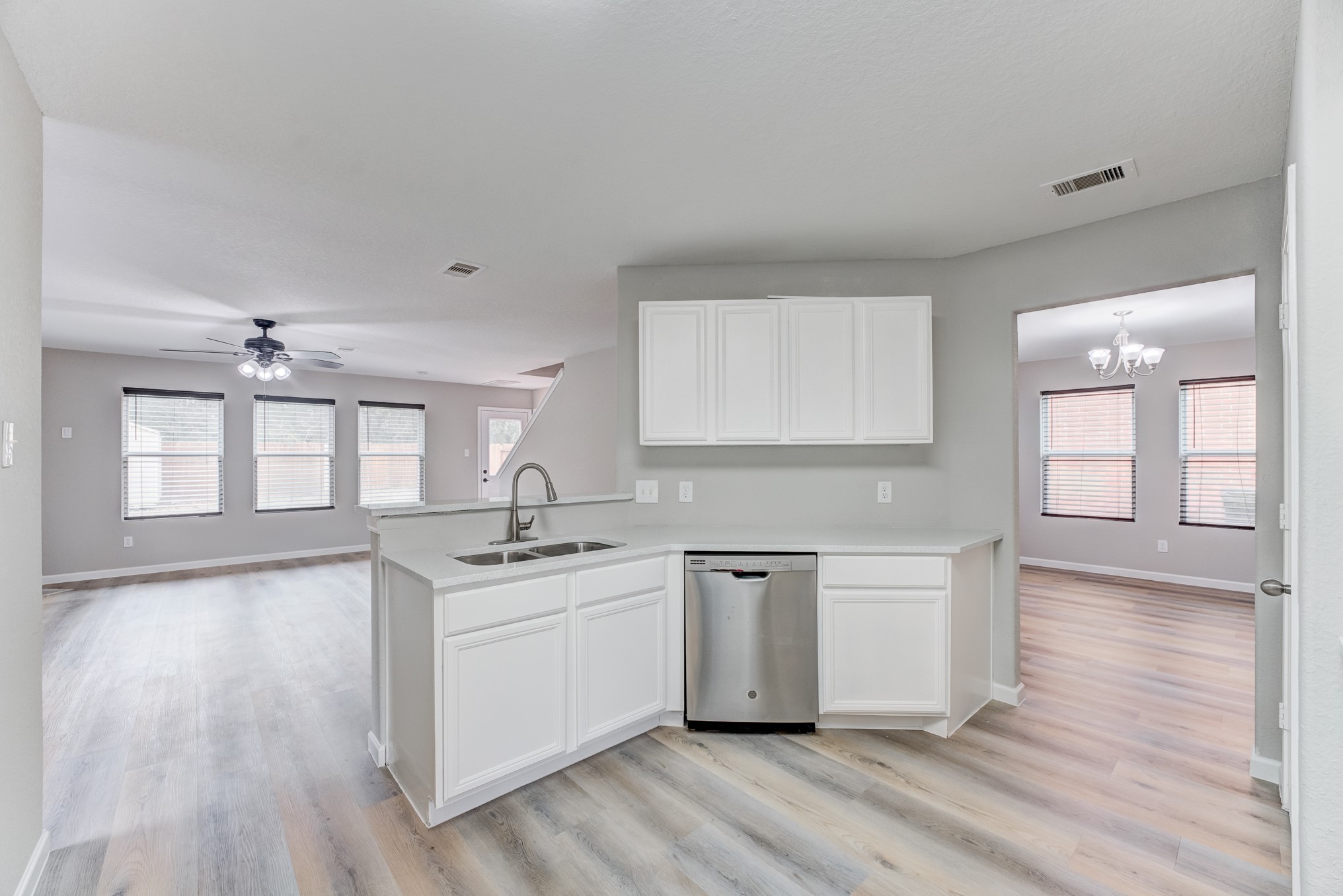 8038 Narrow Brook Way Houston, TX 77016 - Photo 13 of 50 a kitchen with stainless steel appliances granite countertop a sink a stove cabinets and wooden floor